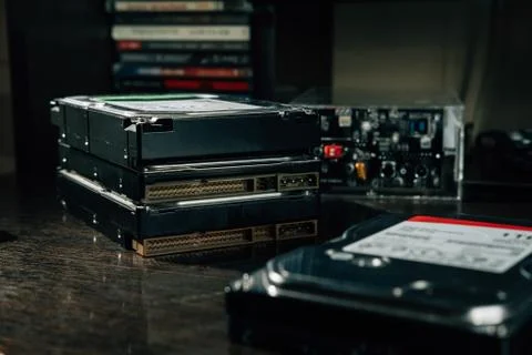 The stack of HDDs on the office table with case for storage data disks Stock Photos