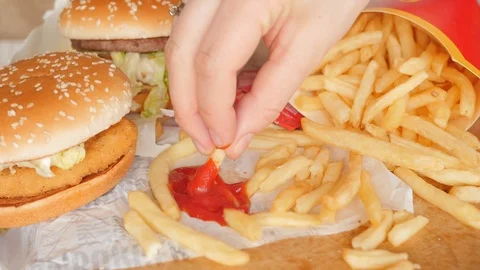 Stack, heap of fast food, eating fries, dipping in ketchup 動画素材 126027272