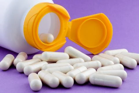 A stack of herbal capsule, dietary supplement, vitamin tablet, herbal medicin Stock Photos