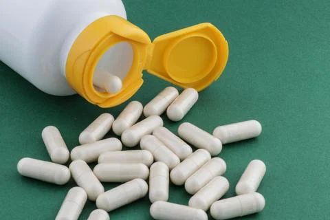 A stack of herbal capsule, dietary supplement, vitamin tablet. Stock Photos