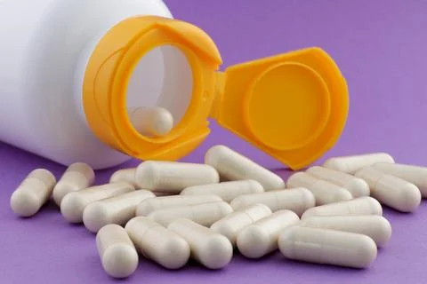 A stack of herbal capsule, dietary supplement, vitamin tablet. Stock Photos