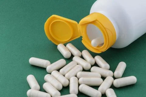 A stack of herbal capsule, dietary supplement, vitamin tablet. Stock Photos