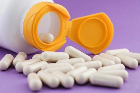 A stack of herbal capsule, dietary supplement, vitamin tablet. Stock Photos