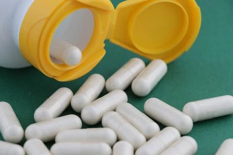 A stack of herbal capsule, dietary supplement, vitamin tablet. Stock Photos