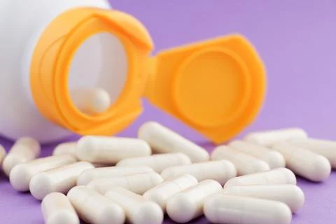 A stack of herbal capsule, dietary supplement, vitamin tablet. Stock Photos