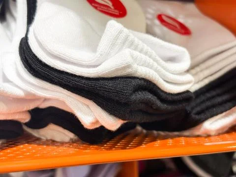 Stack of High-Quality Cotton Socks in Black and White on Retail Display Shelf Stock Photos