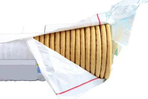 Stack of hole round bread crackers in an open packaging isolated on white backgr Stockfoto's