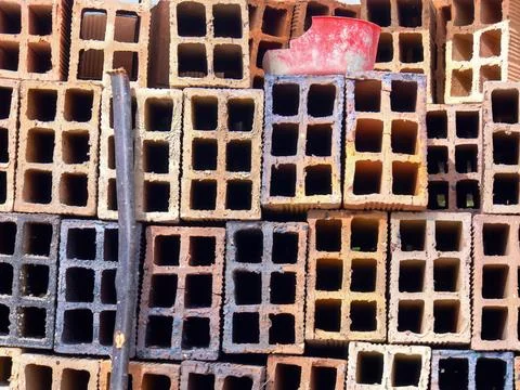 A stack of hollow clay blocks in a construction site, in a farm in the easter Stock Photos
