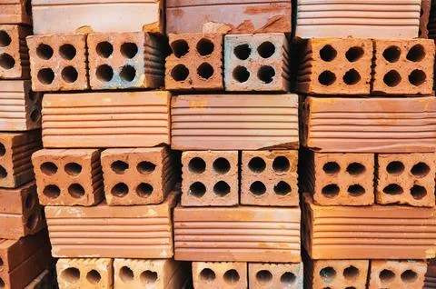 Stack of hollow red bricks on construction site 写真素材