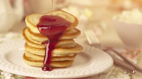 Stack of home-cooked pancakes with pouring jam Stock Footage 57276184