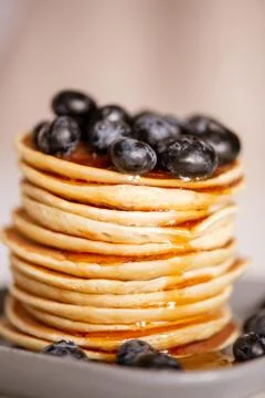 Stack of homemade appetizing crepes with fresh honey and blackberries 스톡 사진