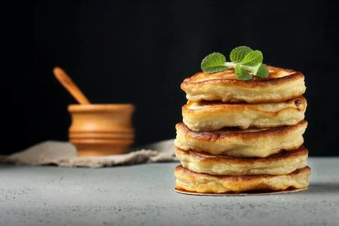 Stack of homemade pancakes with mint on a black background Stock Photos