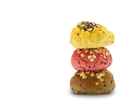Stack of homemade veggie burger buns bread of yellow, pink and brown Foto stock