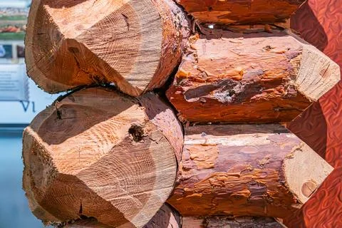 A stack of horizontal rectangular logs, natural wood tones light brown to r.. 스톡 사진