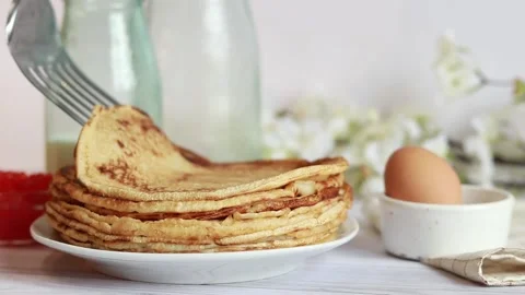 A stack of hot pancakes. Put a new crepes on a stack Stock Footage 234192924