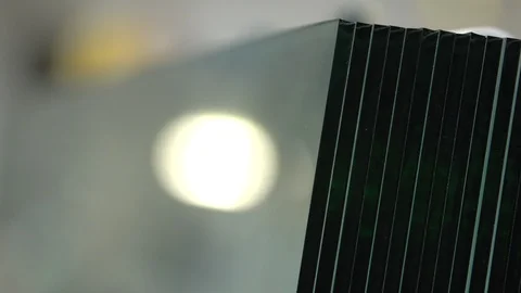 A stack of huge glass panels in the warehouse. Sheets of big tempered Stock Footage 124157117