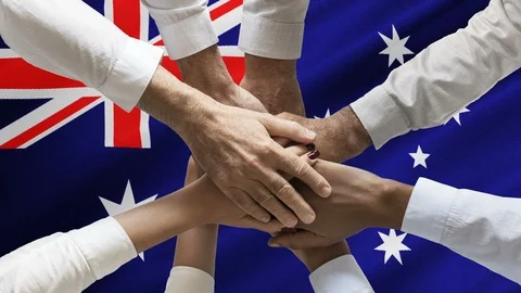 Stack of human hands over animated waving Australian flag Stock Footage 122049700