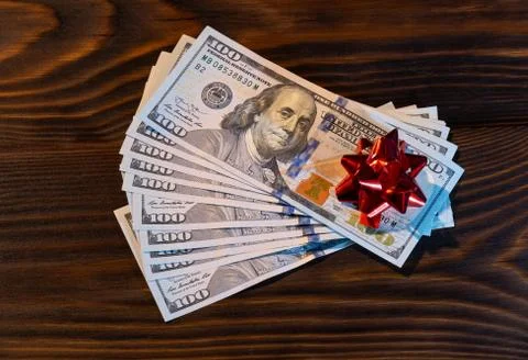 Stack Of Hundred-Dollar Banknotes gift for the new year or christmas. with re Stock Photos