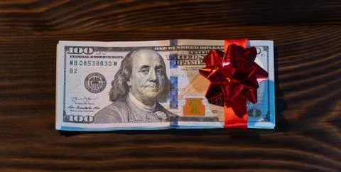 Stack Of Hundred-Dollar Banknotes gift for the new year or christmas. with re Stock Photos