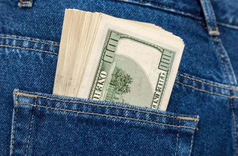 Stack of hundred dollar bills in the back jeans pocket Foto stock