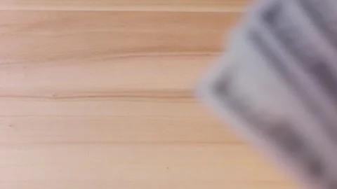 Stack of hundred-dollar bills close-up on a table, concept of income in America. Stock Footage 317211688