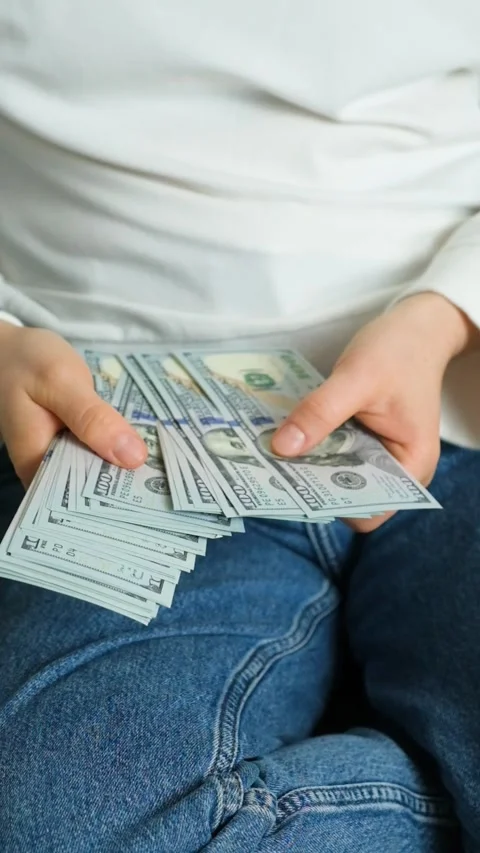 A stack of hundred-dollar bills in hands, the concept of accumulating money Stock Footage 294043098