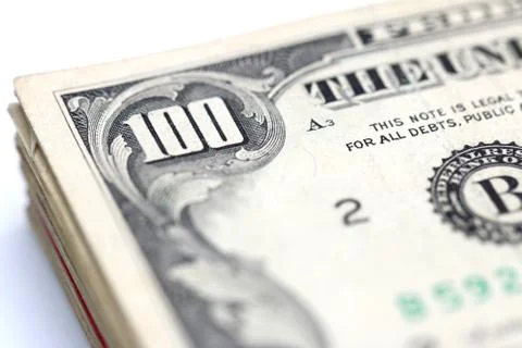 A stack of hundred dollar bills isolated on a white background Stock Photos