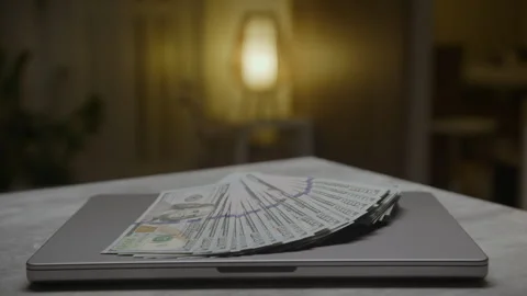 Stack of Hundred Dollar Bills on Laptop Stock Footage 275814535