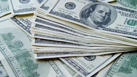 Stack Hundred Dollar Bills Rotates While More Cash Falls In Dramatic Slow Motion Video stock 315355219