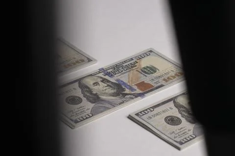 A stack of hundred-dollar bills on a white isolated background. 100 dollar .. Stock Photos