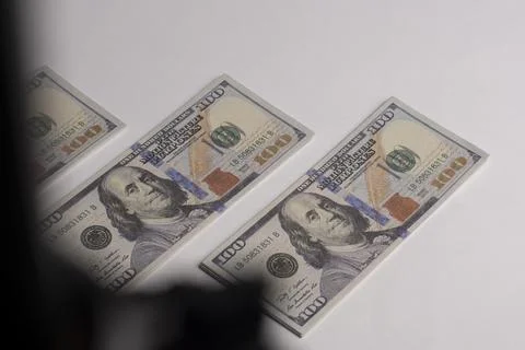 A stack of hundred-dollar bills on a white isolated background. 100 dollar .. Stock Photos