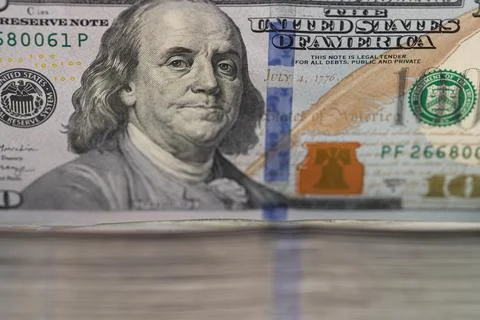 Stack of hundred US dollar bills with selective focus on Benjamin Franklin .. Stock Photos