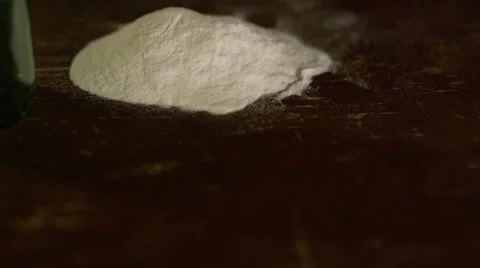 A stack of hundreds falls in front of a pile of cocaine Stock Footage 44258371