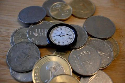 Stack of Hungarian forint coins with clock on top Fotos Stock