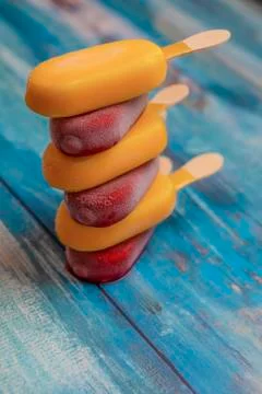Stack of ice cream stick placed on a blue vintage wooden background Stockfoto's