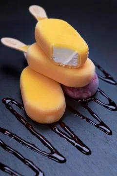 Stack of ice cream stick placed on a black stone background Stock Photos