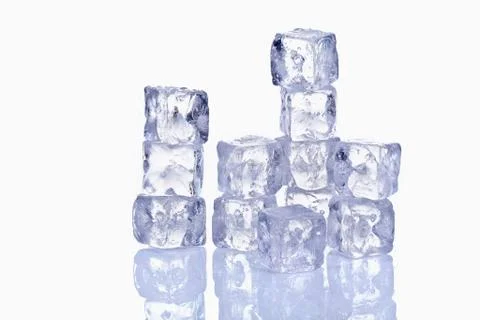 Stack of ice cubes with reflection on glass Stock Photos