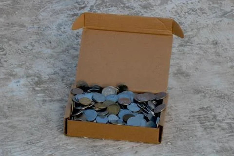 Stack of Indian coins in brown paper box Stock Photos
