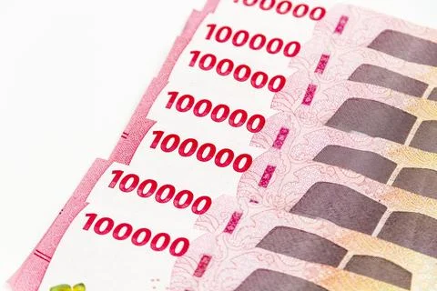 Stack of Indonesian 100,000 Rupiah Banknotes Isolated on White Background Stock Photos
