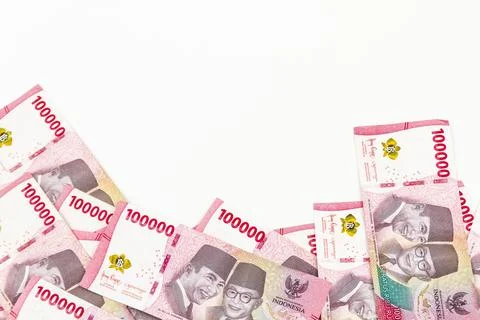 Stack of Indonesian 100,000 Rupiah Banknotes Isolated on White Background Stock Photos