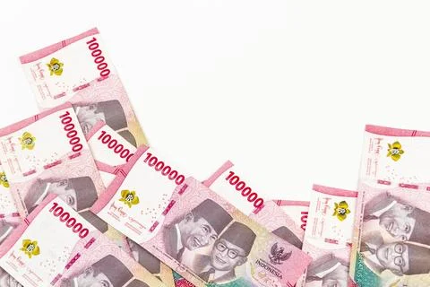 Stack of Indonesian 100,000 Rupiah Banknotes Isolated on White Background Stock Photos