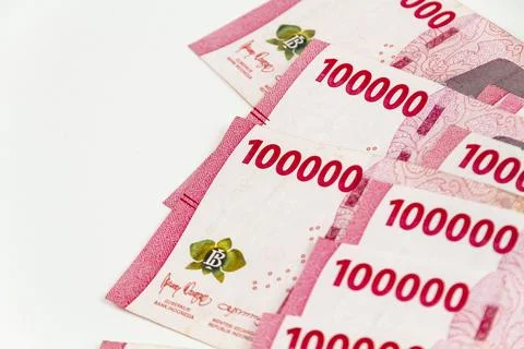 Stack of Indonesian 100,000 Rupiah Banknotes Isolated on White Background Stock Photos
