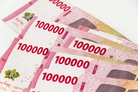 Stack of Indonesian 100,000 Rupiah Banknotes Isolated on White Background Stock Photos