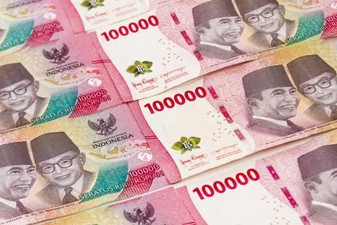 Stack of Indonesian 100,000 Rupiah Banknotes Isolated on White Background Stock Photos
