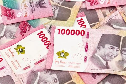 Stack of Indonesian 100,000 Rupiah Banknotes Isolated on White Background Stock Photos