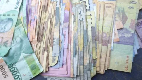 Stack of Indonesian banknotes on the table Stock Photos