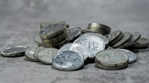 Stack of Indonesian Rupiah currency coins on a gray background with concret.. Stock Photos