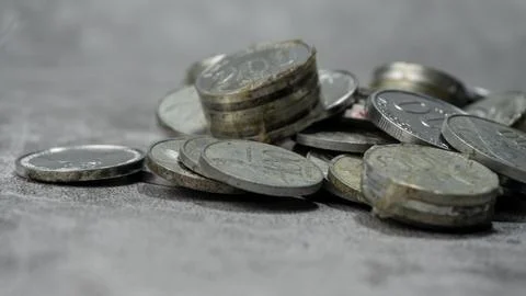 Stack of Indonesian Rupiah currency coins on a gray background with concret.. Stock Photos