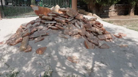 Stack of industrial material on construction site, sand and orange rock stone Stock Footage 228969379