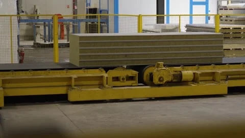 Stack of Insulated Panels Moving on Motorized Factory Trolley Stock Footage 336777672